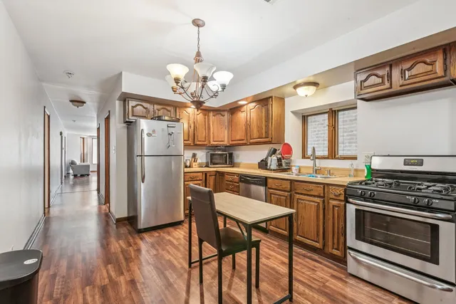 a kitchen with stainless steel appliances a stove a sink and cabinets