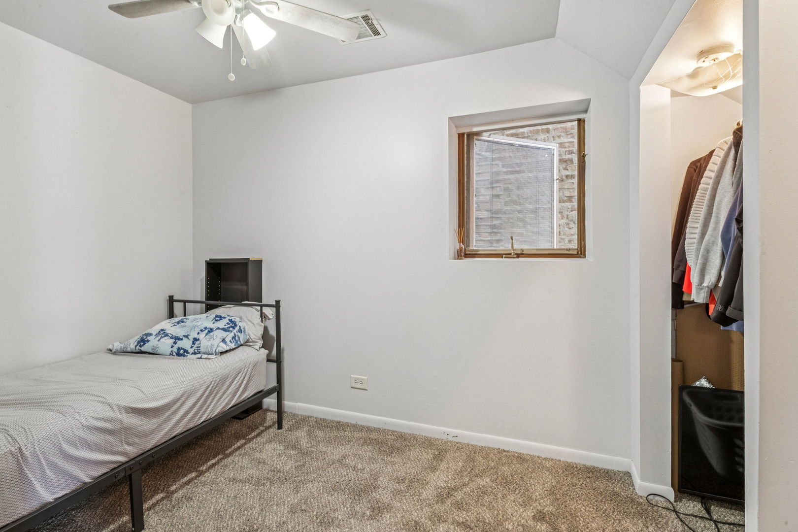 3234 South Princeton Avenue Chicago, IL 60616 - Photo 40 of 56 a bedroom with a bed and a chandelier