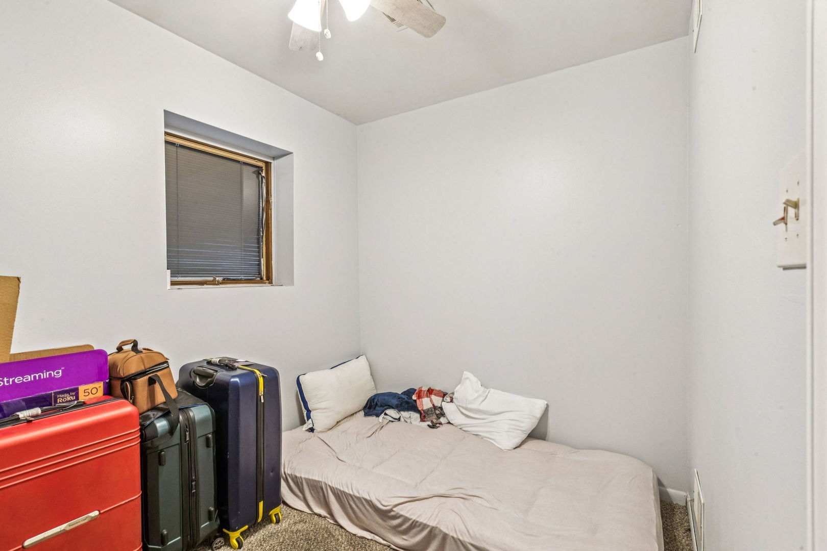 3234 South Princeton Avenue Chicago, IL 60616 - Photo 43 of 56 a bedroom with a bed and a chandelier