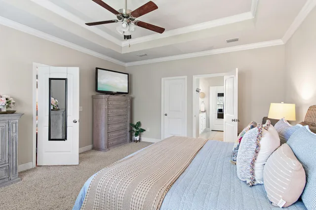 a bedroom with a bed and a chandelier
