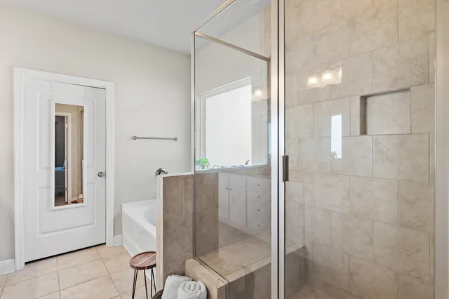 a bathroom with a glass shower door and mirror