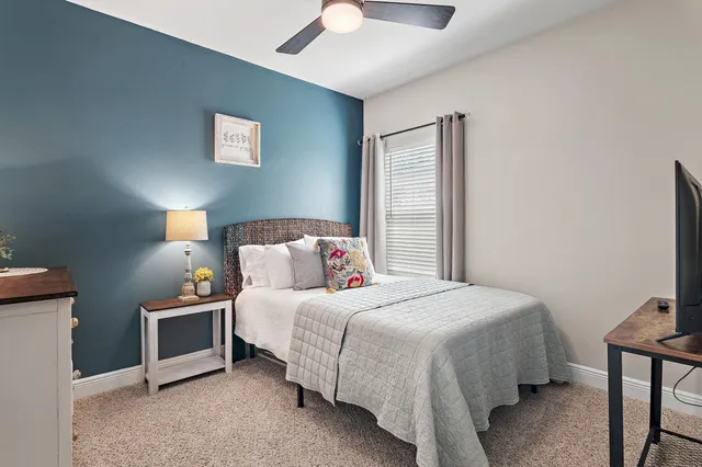 a bedroom with a bed and a night stand