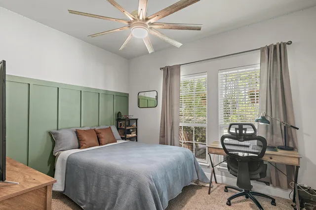 a bedroom with a large bed and a window