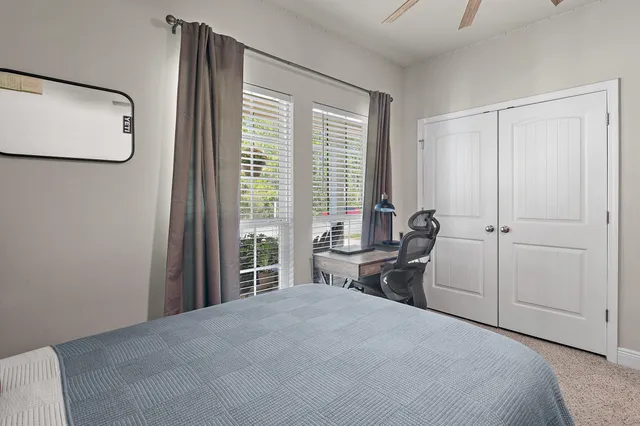 a bedroom with a large bed and a chandelier