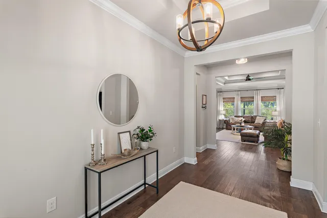 a living room with furniture a mirror and a table