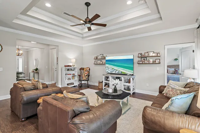 a living room with furniture ceiling fan and a rug