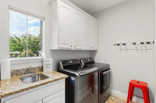 a kitchen that has a sink and a stove
