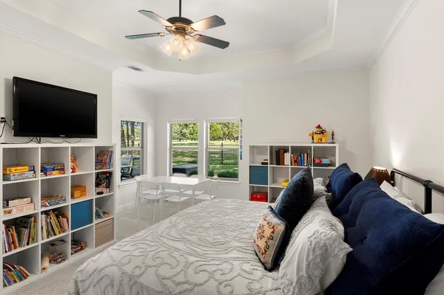 a bed room with a bed a television and a window