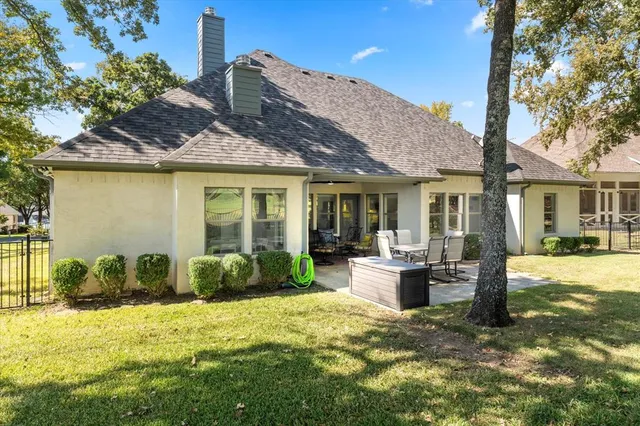 a front view of a house with a garden and patio