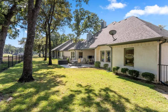 a swimming pool with outdoor seating and yard