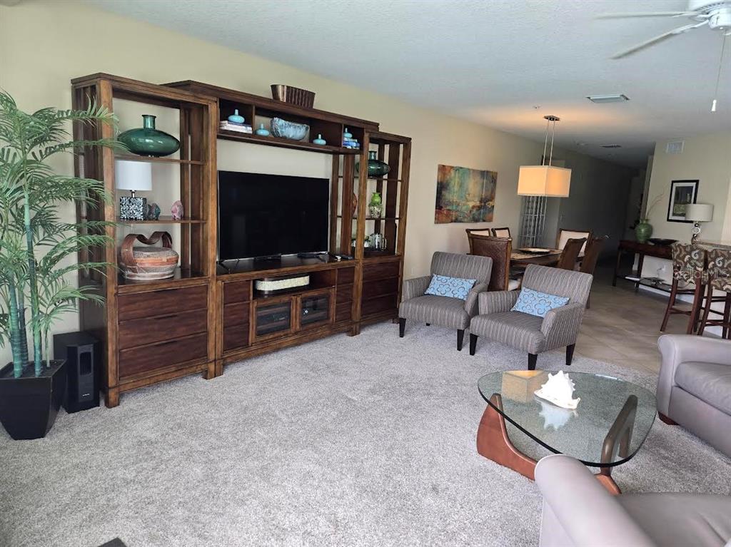 650 Golden Gate Point, Unit 301 Sarasota, FL 34236 - Photo 14 of 31 a living room with furniture and a flat screen tv