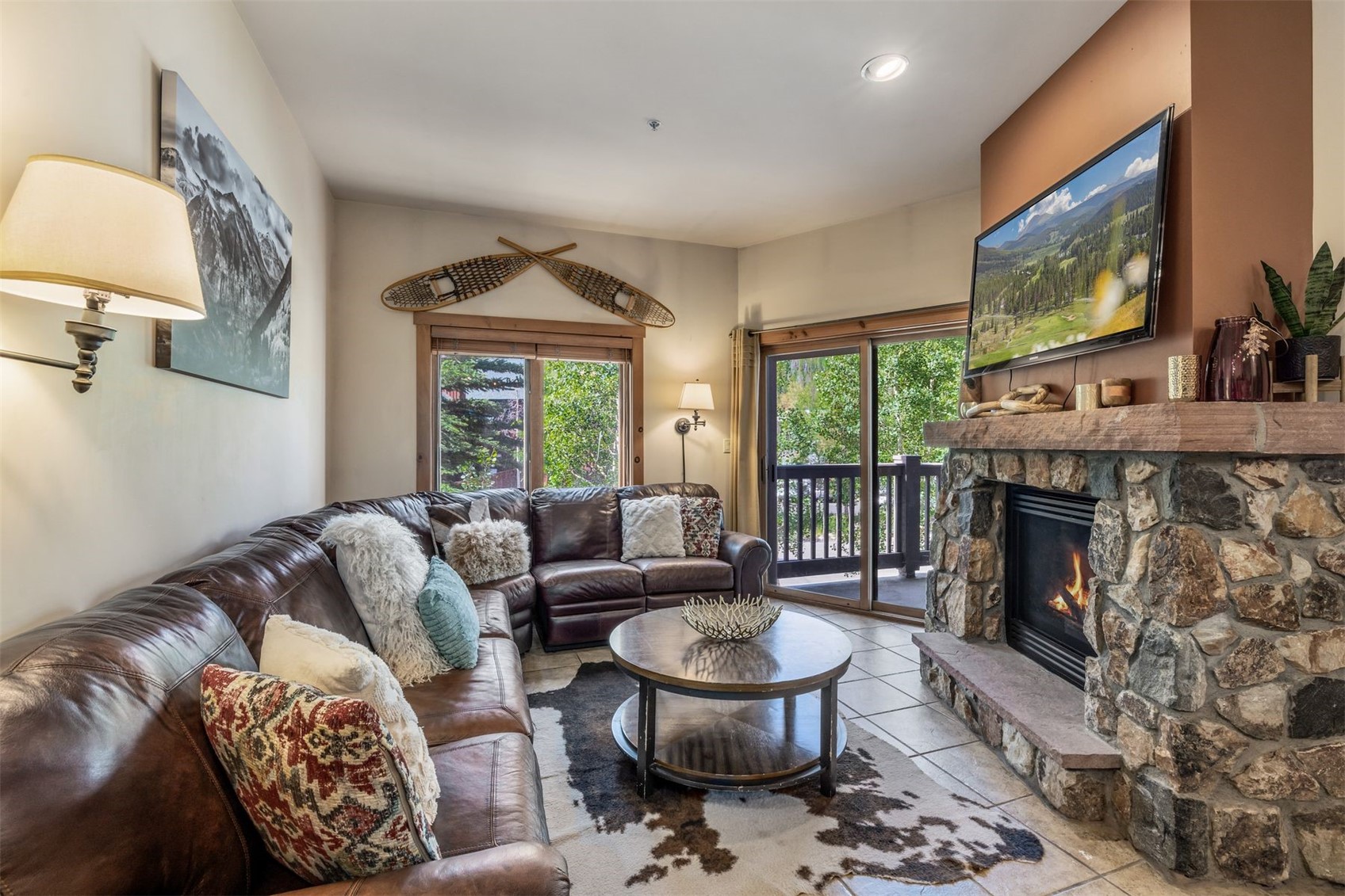 a living room with furniture a fireplace and a flat screen tv