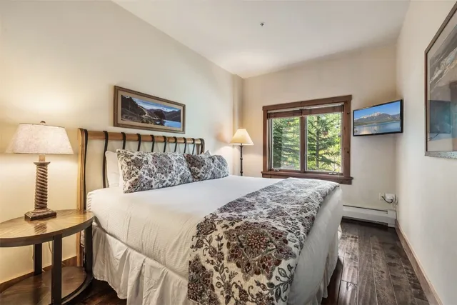 a bed sitting in a bedroom next to a window