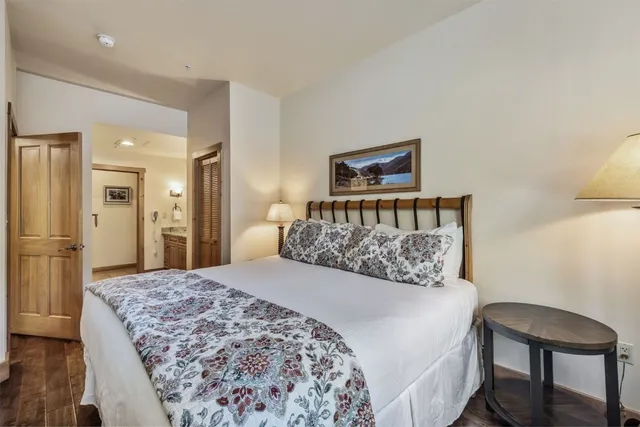 a bedroom with a bed and a table in it