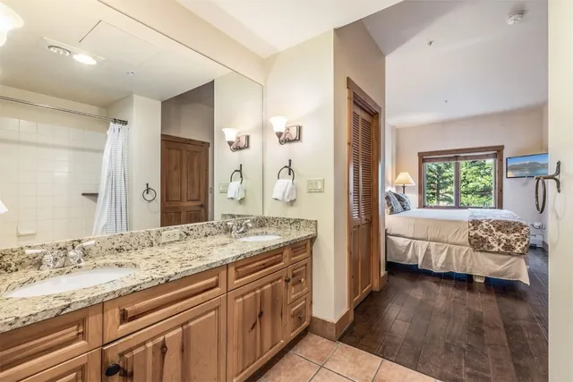 a spacious bathroom with a granite countertop tub sink and mirror