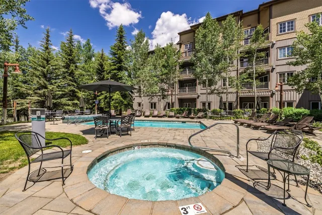 a view of a swimming pool with outdoor seating