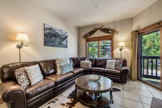 a living room with furniture a window and a chandelier