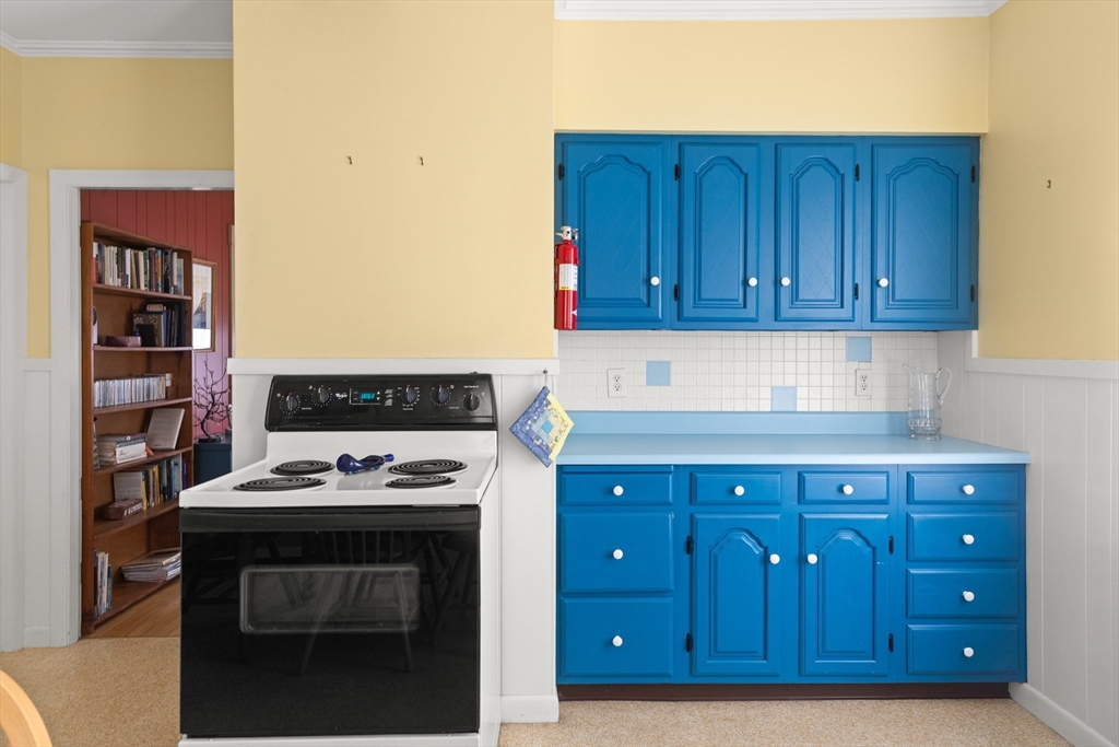 56 Washington Street Gloucester, MA 01930 - Photo 12 of 29 a kitchen with stainless steel appliances granite countertop a stove and a refrigerator