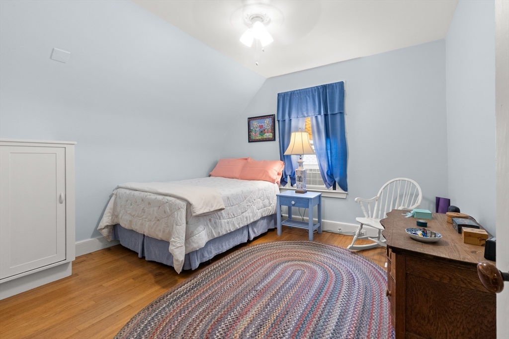 56 Washington Street Gloucester, MA 01930 - Photo 17 of 29 a bedroom with a bed and wooden floor