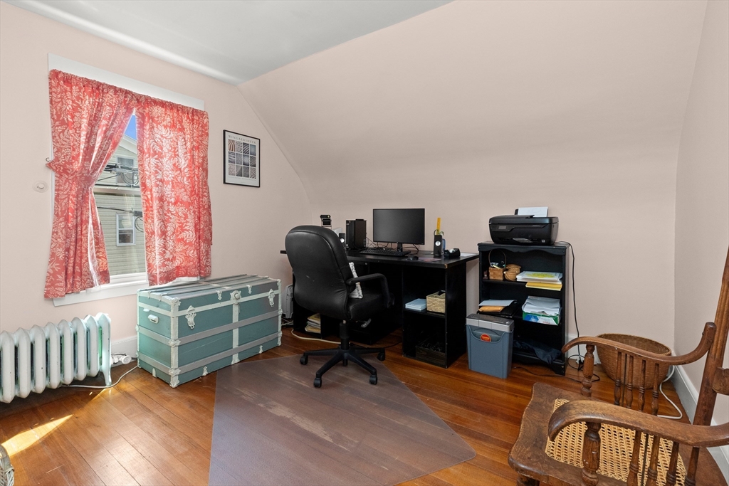 56 Washington Street Gloucester, MA 01930 - Photo 19 of 29 a view of a workspace with furniture and a window
