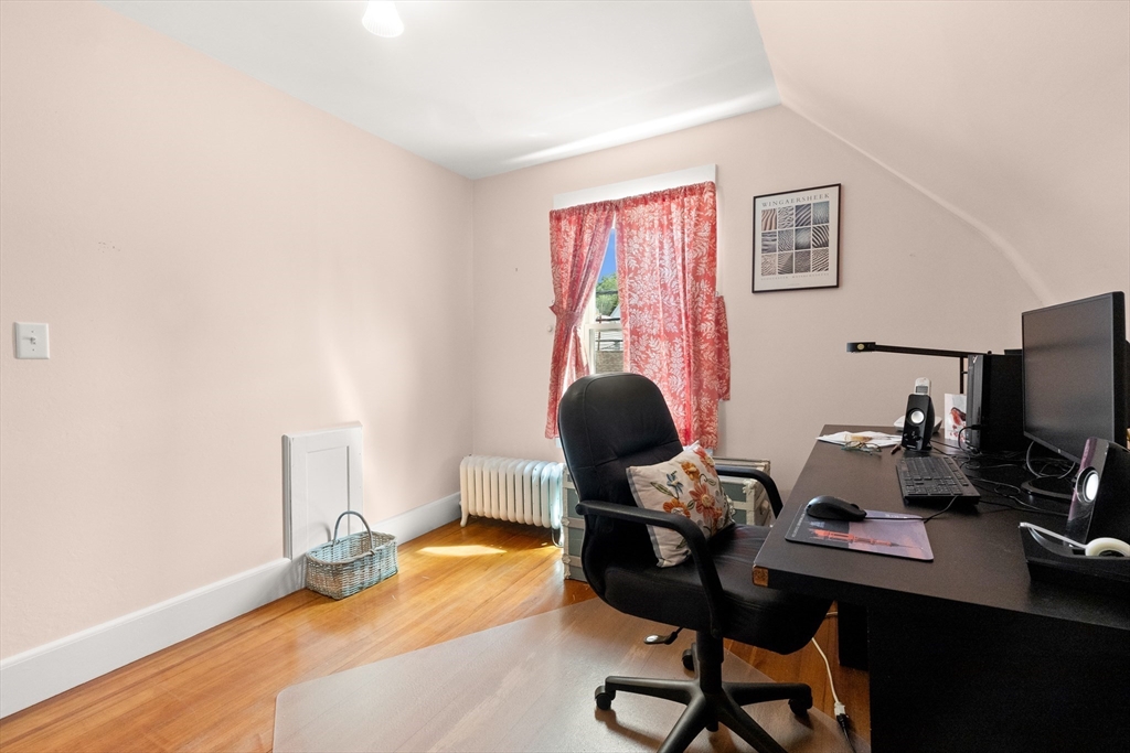 56 Washington Street Gloucester, MA 01930 - Photo 20 of 29 a view of a workspace with furniture and a window