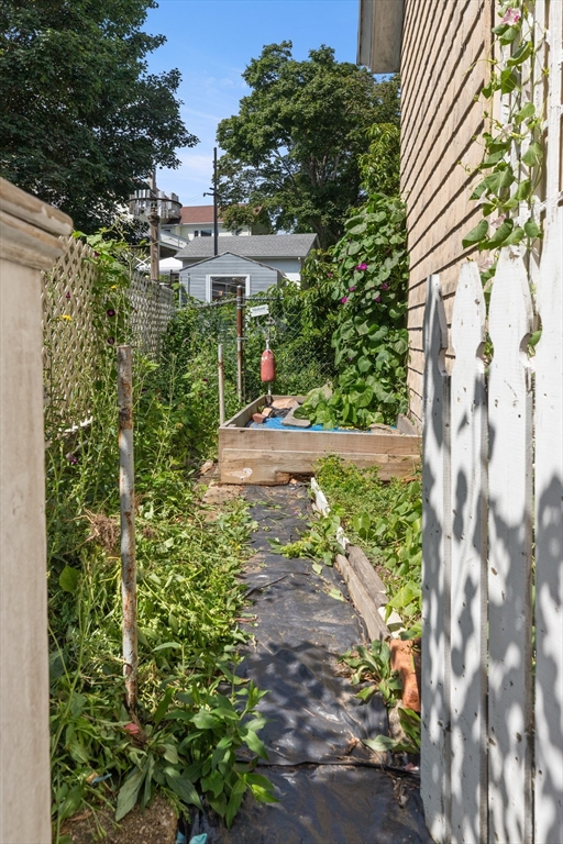 56 Washington Street Gloucester, MA 01930 - Photo 26 of 29 a aerial view of a house with a yard and garden