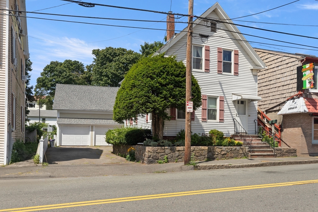 56 Washington Street Gloucester, MA 01930 - Photo 3 of 29 a front view of a house with a yard and garage