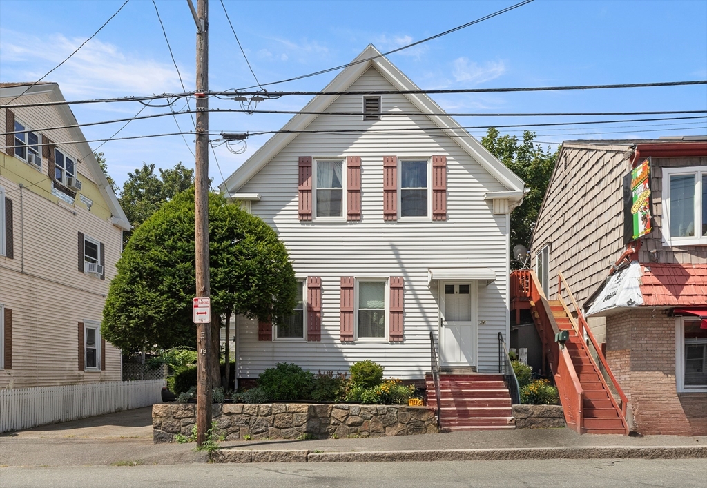 56 Washington Street Gloucester, MA 01930 - Photo 4 of 29 a front view of a house with a yard