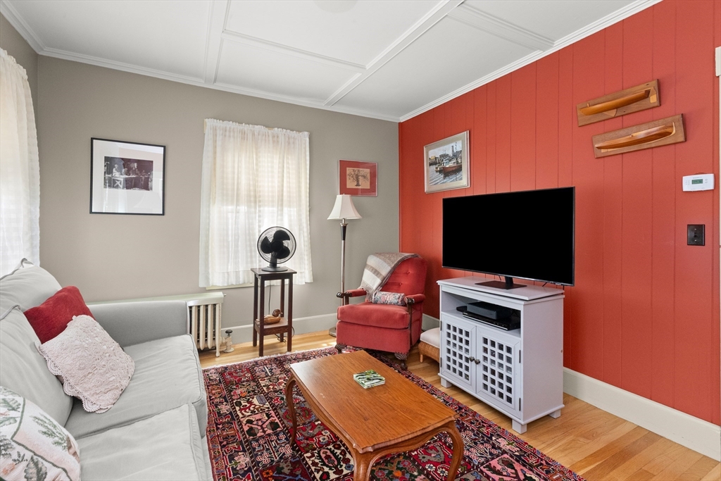 56 Washington Street Gloucester, MA 01930 - Photo 7 of 29 a living room with furniture and a flat screen tv