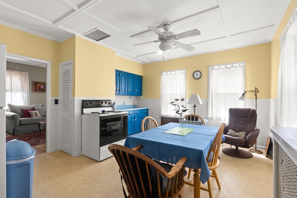 56 Washington Street Gloucester, MA 01930 - Photo 10 of 29 a view of a dining room with furniture and a chandelier