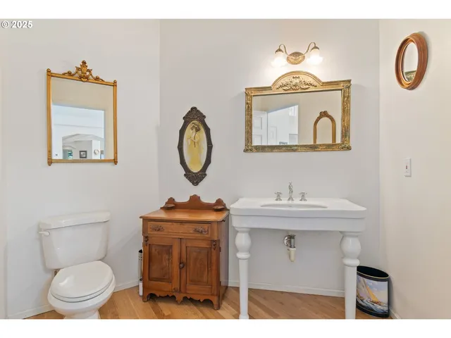 a bathroom with a toilet a sink and a mirror