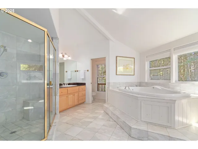 a large white kitchen with a large window