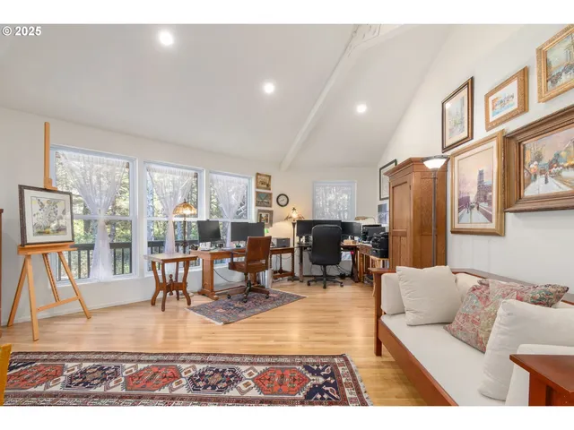 a living room with furniture and a dining table with rug floor