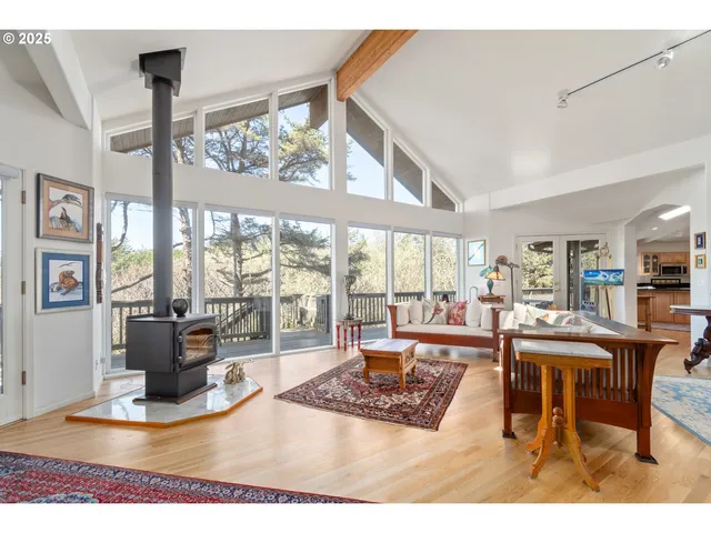 a living room with couches a coffee table and a large window with outer view
