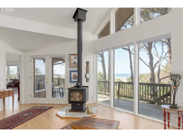 a living room with hardwood floor and a floor to ceiling window