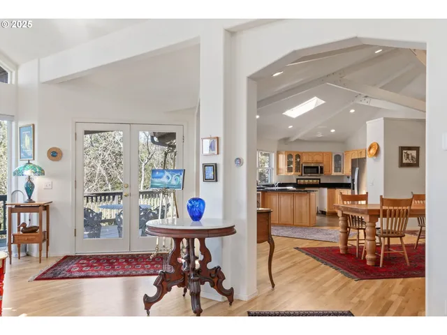 a living room with furniture and kitchen view