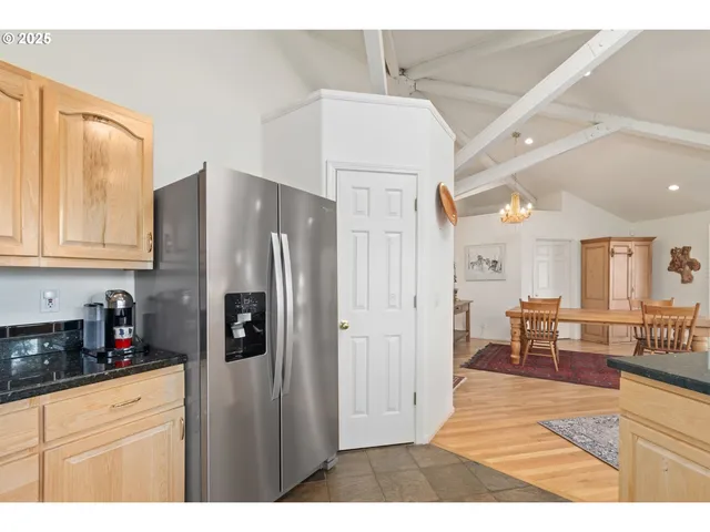 a kitchen with stainless steel appliances a refrigerator and cabinets