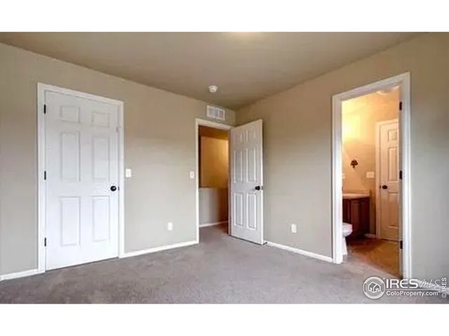 a living room with a hallway and a dining table