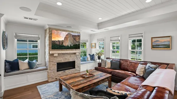 a living room with furniture fireplace and window