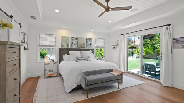 a spacious bedroom with a bed and a large window