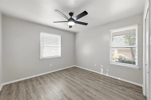 wooden floor in an empty room with a window