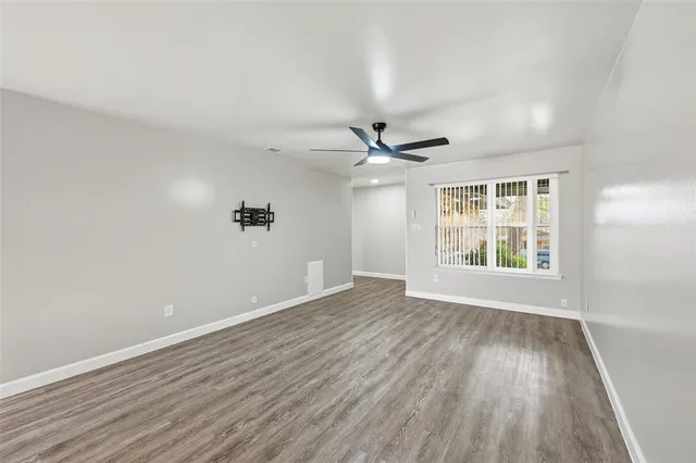 wooden floor in an empty room with a window