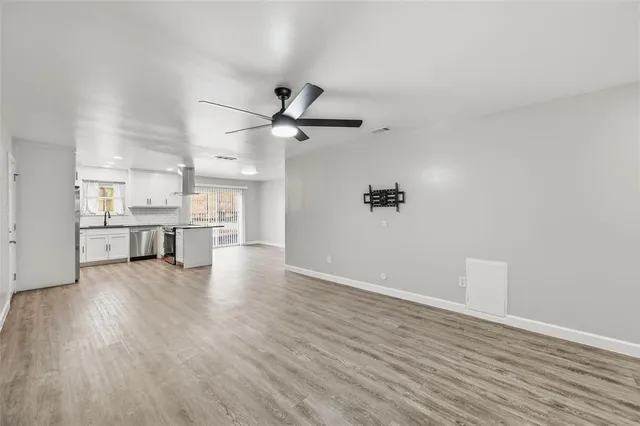 a view of a kitchen with a sink and a refrigerator