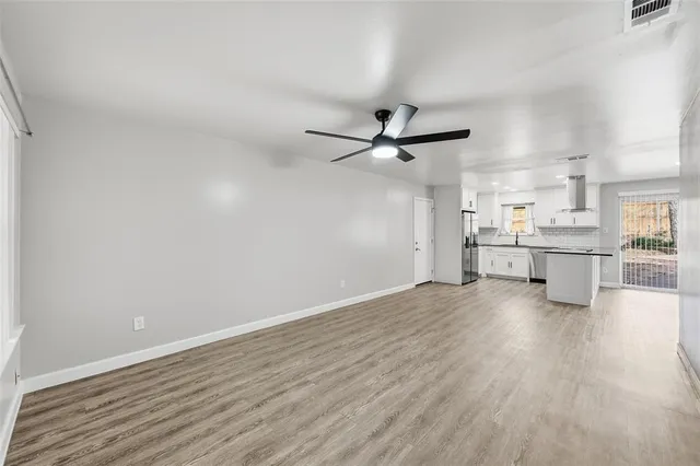 a view of a kitchen with a dishwasher a microwave oven with wooden floor