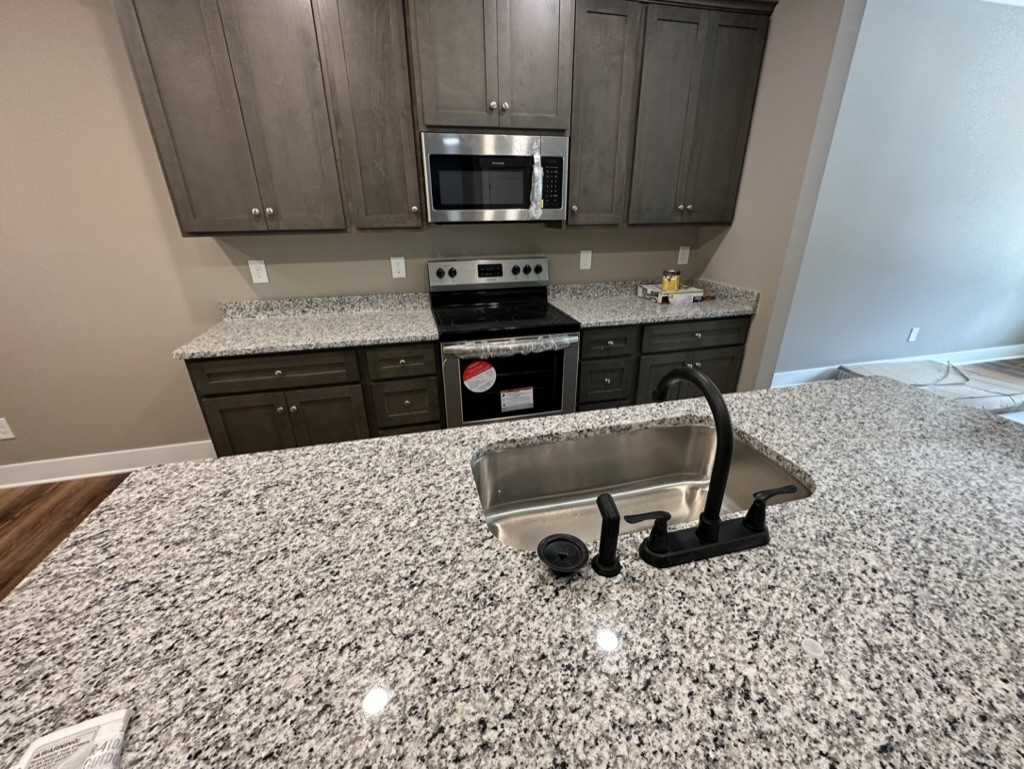412 South Aztec Drive White House, TN 37188 - Photo 4 of 15 a kitchen with a sink a stove a microwave and cabinets
