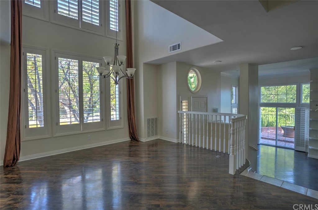 2 Chandon Newport Coast, CA 92657 - Photo 5 of 22 a view of an entryway door with hallway view with wooden floor and windows