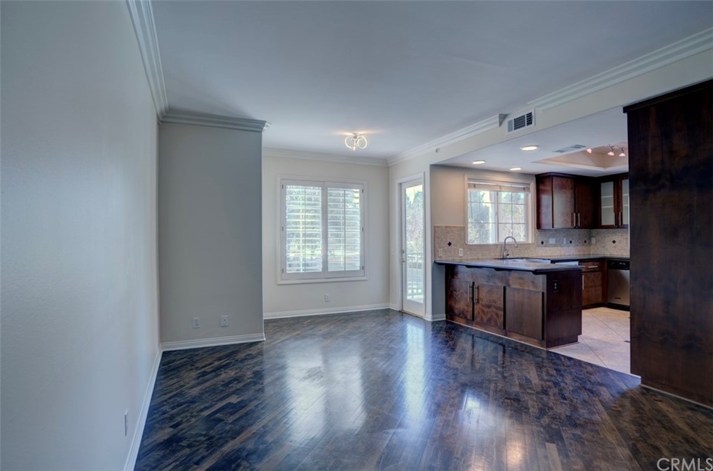 2 Chandon Newport Coast, CA 92657 - Photo 7 of 22 a open kitchen with stainless steel appliances granite countertop a refrigerator a sink a stove and oven with wooden floor