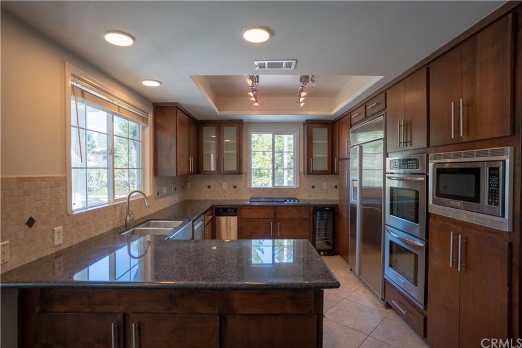 2 Chandon Newport Coast, CA 92657 - Photo 8 of 22 a kitchen with a sink a counter space appliances and cabinets