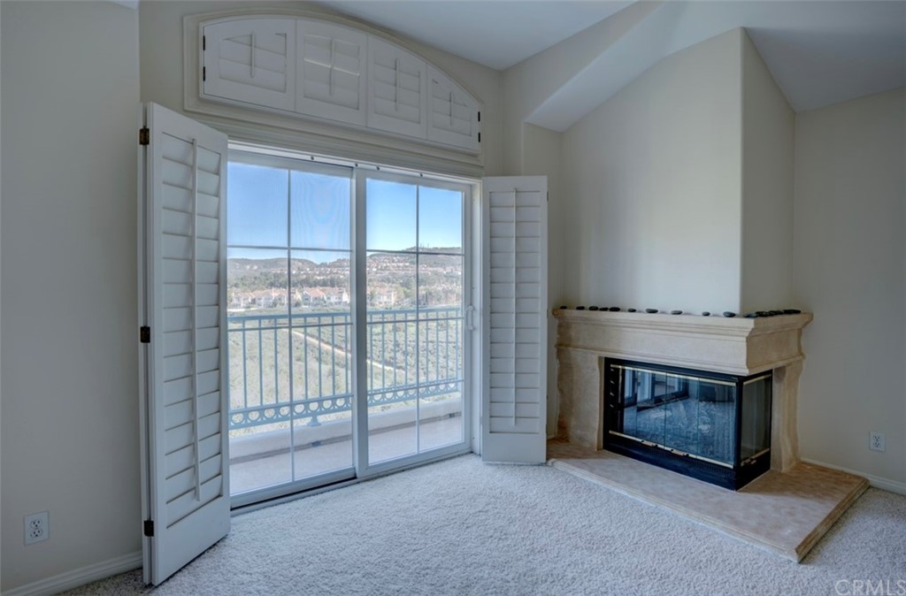 2 Chandon Newport Coast, CA 92657 - Photo 10 of 22 a view of an empty room with a fireplace and a window
