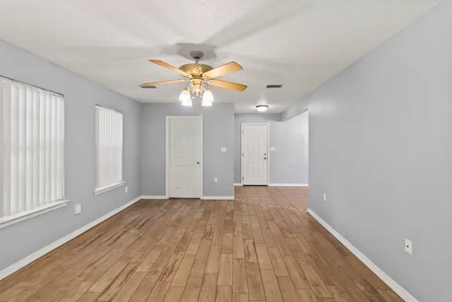 wooden floor in an empty room with a window